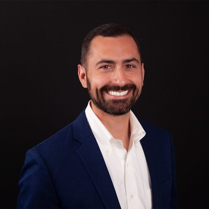 Headshot of smiling young man, taken by Cork Tree Creative