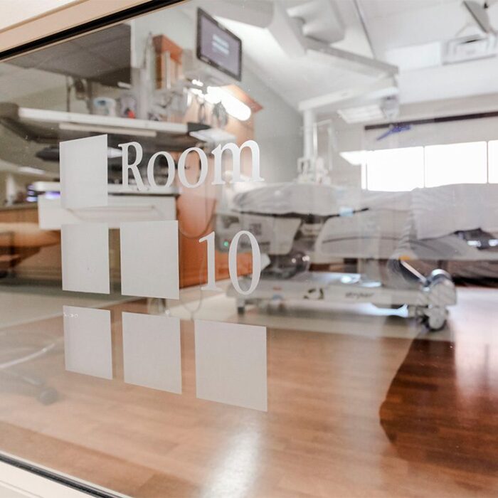 Closeup of Room number, with hospital room in background at Anderson Hospital